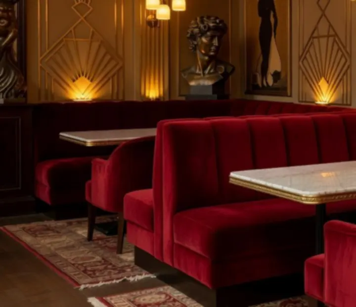 Banquettes en velours et tables sculpturales dans le lounge du Bistro du Parc